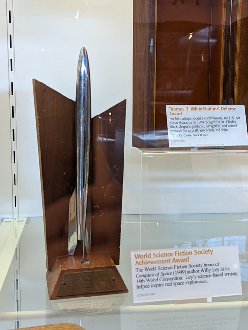 Willy Ley's Hugo Award: silver rocket on a trapezoidal wooden base, brass plaque, with wooden back.