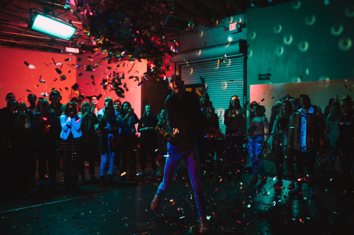Audience member breaking open the disco piñata for our Pop-Up Show 🕺