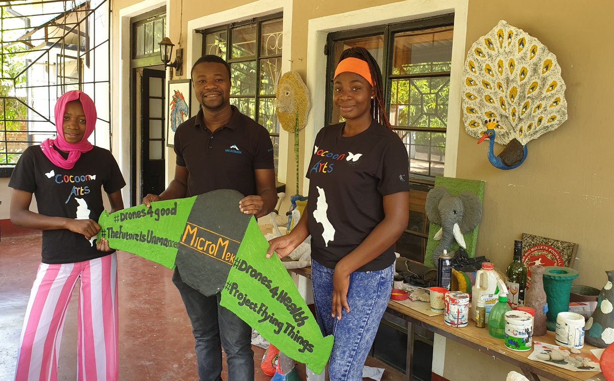 MicroMek_LTD's tweet photo. Takondwa & Jasmine gave #MicroMek a mockup #drone gift today! They are part of the Cocoon Arts team, growing inside our center @TheMakerzSpace, & makes creative art from recycled paper & #waste in #Blantyre #Malawi. Their work represents our focus on a greener #emobility future. https://t.co/iAL8wxjLe4