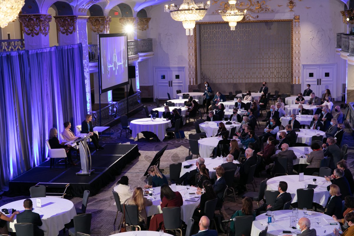 Image of ballroom with speakers on stage (left of photo).