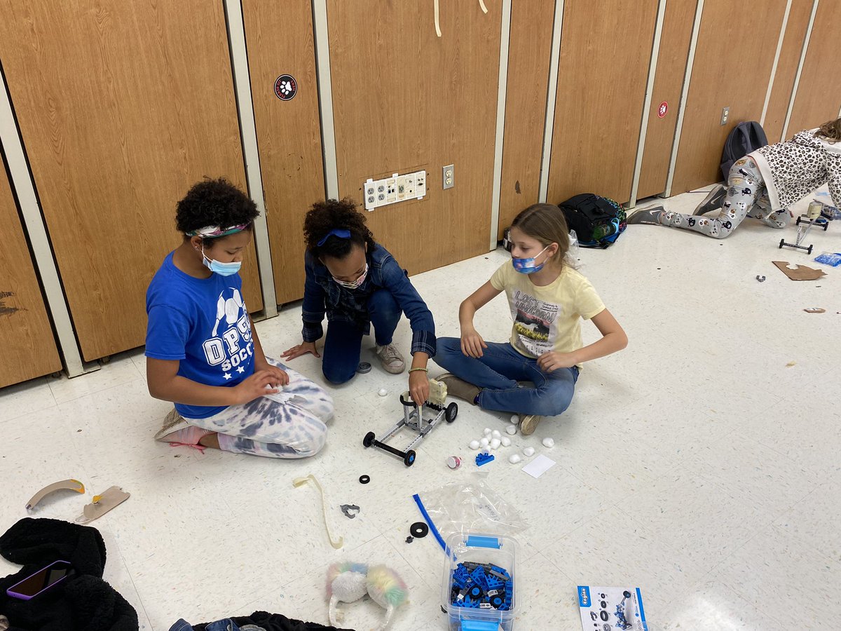 YIS STEM club doing some serious car building tonight!