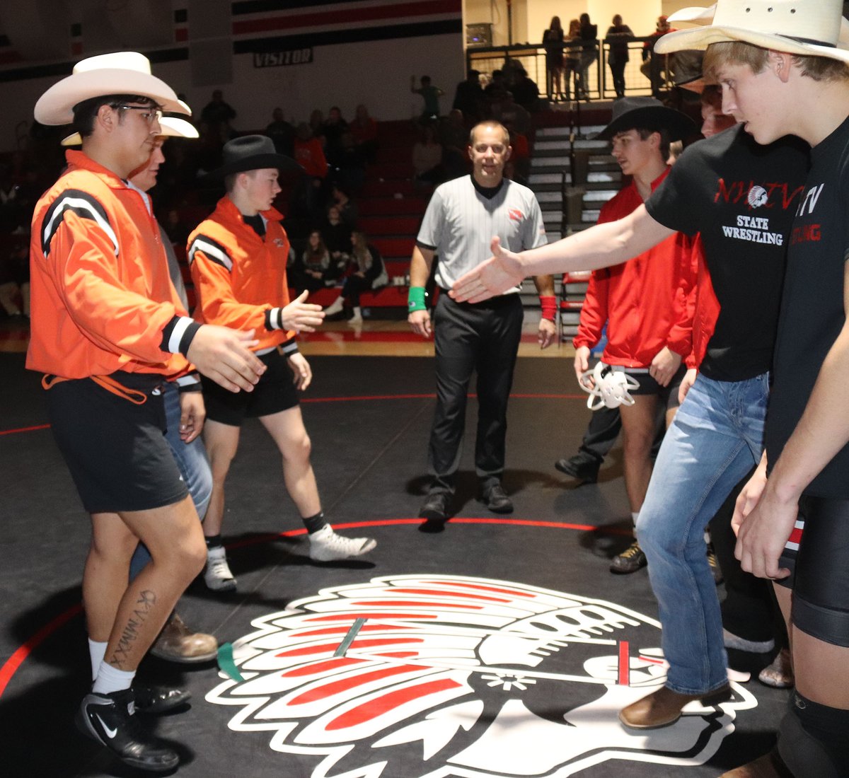 CCPressSports's tweet photo. Captains from Charles City and NHTV meet in the center of the mat before their dual as part of Thursday’s wrestling triangular hosted by NHTV. The cowboy hats are in memory of longtime wresting supporter Mike Reams.
https://t.co/rit1YQTlzr…e-fan-mike-reams/ https://t.co/EGr3WcKpRF