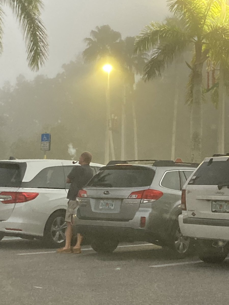 jarodzsz's tweet photo. this man smoking a pipe in a foggy publix parking lot... this is what 2022 is about https://t.co/U11dHxEKYA