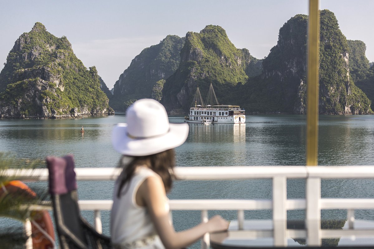 HeritageLine's tweet photo. A guest aboard Heritage Line Jasmine gazes upon sister ship, Violet, set amongst the picturesque landscapes of Halong Bay.

Our luxurious Halong Bay ships:
Violet - https://t.co/RcJIJZqvDk
Jasmine - https://t.co/f2o1mW49kK https://t.co/9jwUJPWORS