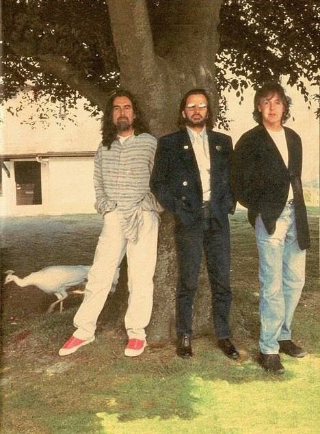 BeatlesEarth's tweet photo. In 1996, the three remaining Beatles reunited. They were feeling empty during the photoshoot without John Lennon being there. A white peacock then mysteriously appeared behind George for one of the photos. When they saw it, they all felt John’s presence and the mood was lifted. https://t.co/eBnhEOMRLz