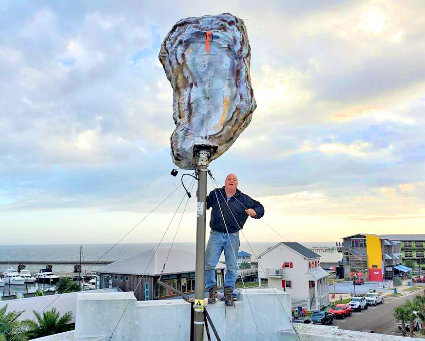 ShooflyMagazine's tweet photo. Artist Steve Barney on the roof of 200 N. Beach Restaurant with the main prop for the city's New Year's Eve celebration, the Oyster Drop!

Find complete details on the Shoofly Magazine's Upcoming Events page! 
https://t.co/RbMwjw16dE https://t.co/OcLihDHgV0