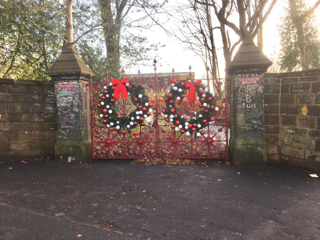 Festive cheer at the gates to #StrawberryFields in #Liverpool. New Year's Eve and a there's a steady procession of overseas tourists wanting to follow in the footsteps of #JohnLennon. The #Beatles legacy is as important to Liverpool as #Shakespeare was to #StratfordUponAvon.