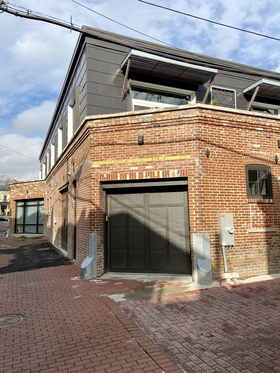 CasesinVirginia's tweet photo. First up is a garage in Columbia Heights. I love alleys so I knew exactly where this was and what was going on today—luxury alley dwellings. Not what was condemned in the mid 20th century. Nice color on bricks along with the “you can’t afford this gray.” https://t.co/sQvxTo4IcY
