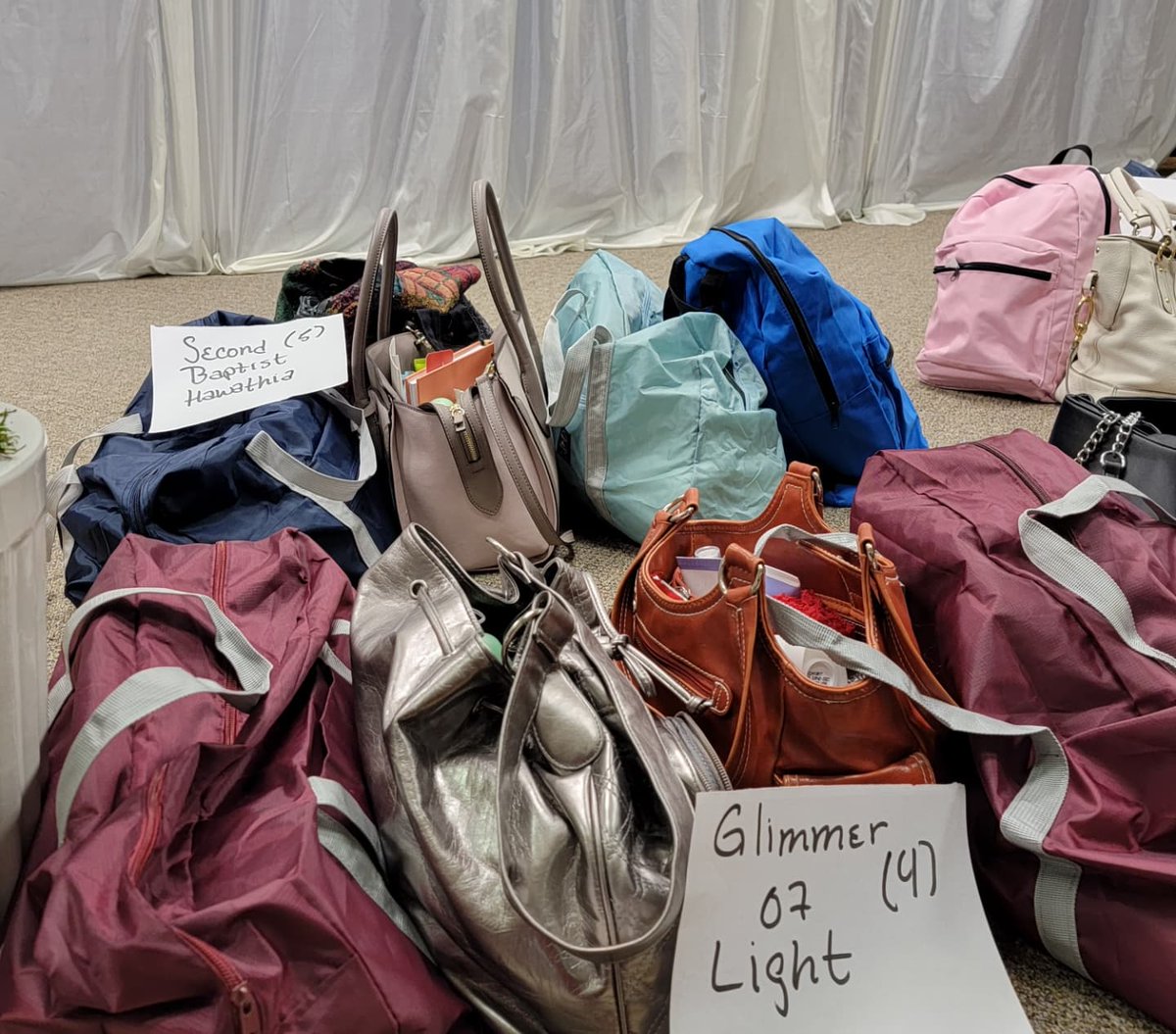 LVAC_DST's tweet photo. New and gently used purses, totes and duffle bags filled with personal care items and inspirational messages -- care of LAC's "Bags and Bonnets" initiative -- were distributed to women in Leavenworth as part of #c3regiondst "My Sisters' Keeper" effort for Christmas. https://t.co/uWP7m7gL6q