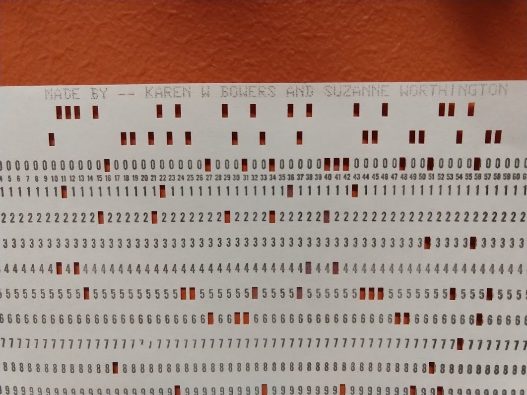 Punch cards were critical for data processing from the 1920s to the 1980s. The 80-column card held one character per column. Typically one digit is punched along with a "zone" punch at the top to specify a letter. This card formed the caption for the wreath.