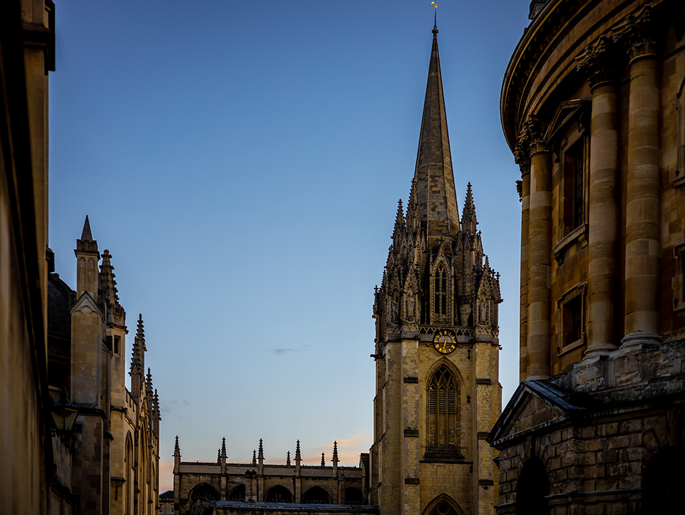 Sunset behind a spire of Oxford next to the Radcliffe Camera