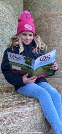 Hailey Curtis studying the 2022 forage seed guide.