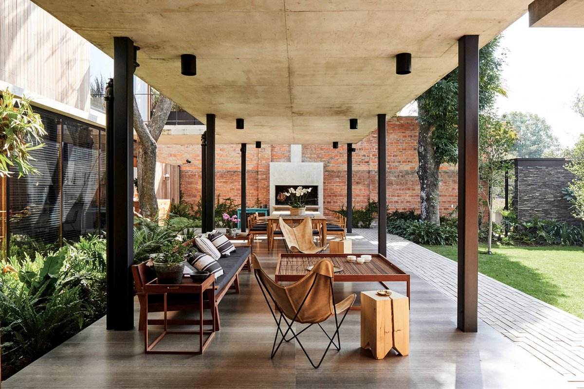 dezeen's tweet photo. Browse 10 outdoor spaces with warming fireplaces and fire pits: https://t.co/mV53b6G1Ip https://t.co/5kuBhWIGJj