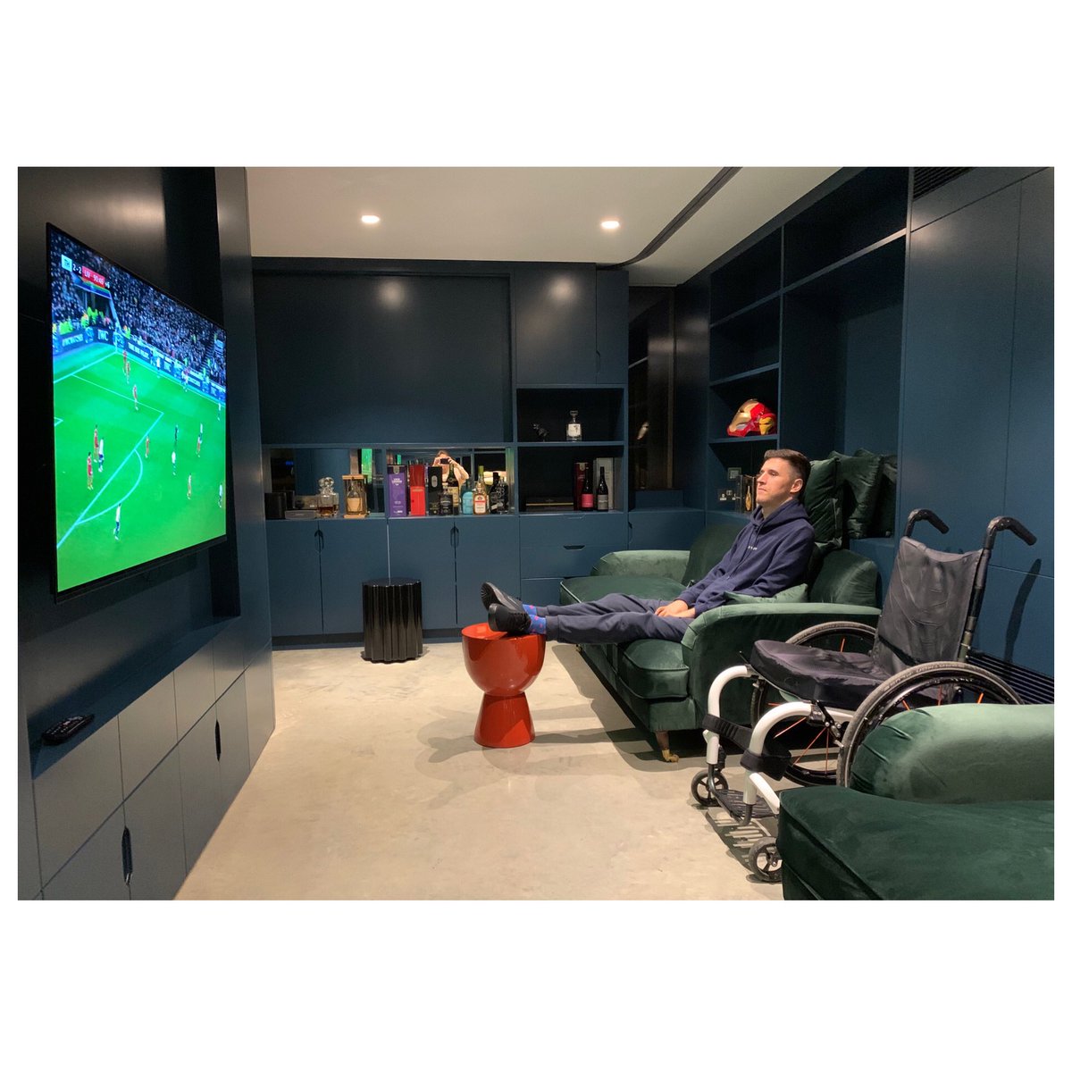 I’m on the sofa.

I have recently moved into my own home after a year long build. In the snug I had a ceiling hoist fitted, you can see the track in the ceiling, so that I could actually sit on the sofa. It lifts me from my chair using a sling that is put under me.