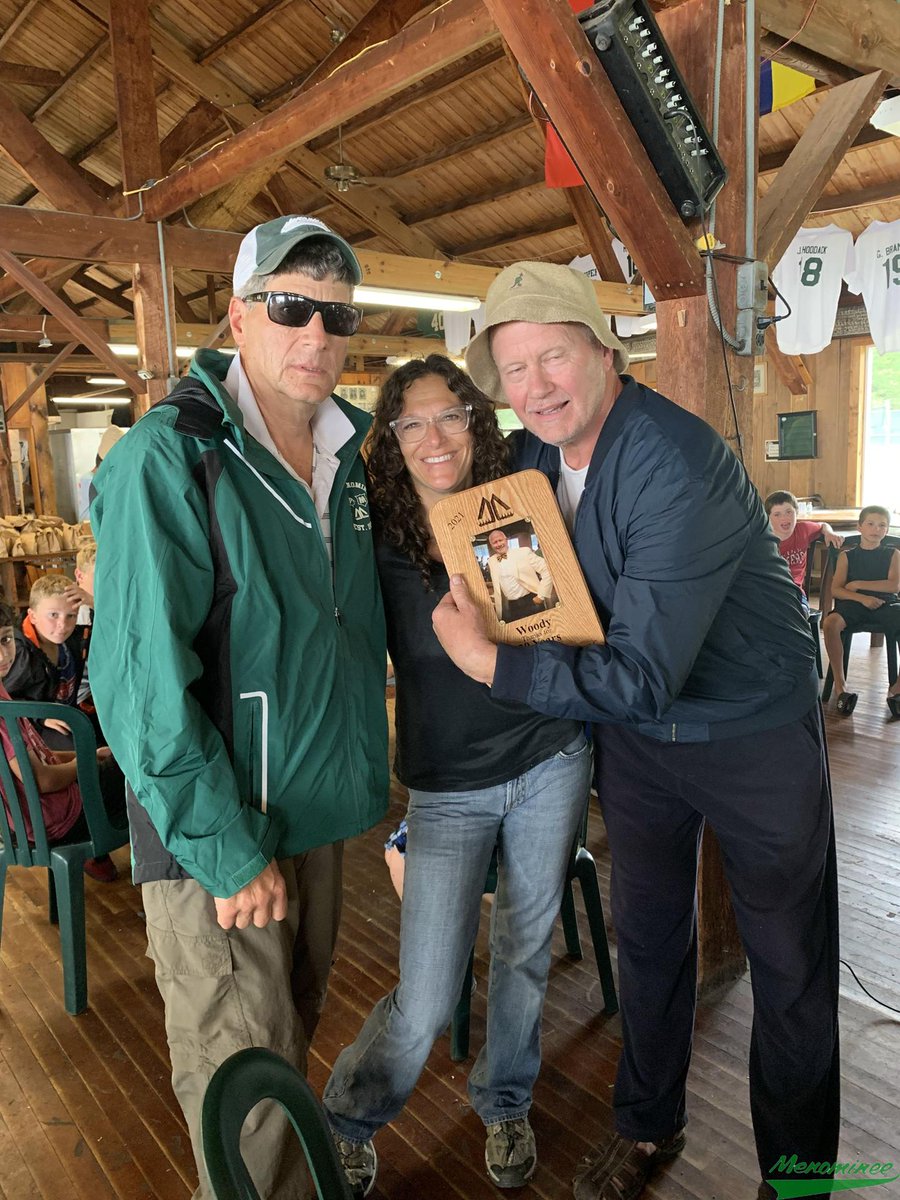 CampMenominee's tweet photo. Tom, Pam, and those of Green Nation assembled in the Mess Hall celebrating Woody's 30 Years at Menominee! #CMLegends #CMRoyalty #CMFamily #BleedingGreen #OverThePond 💚 https://t.co/34DOyPKXEx
