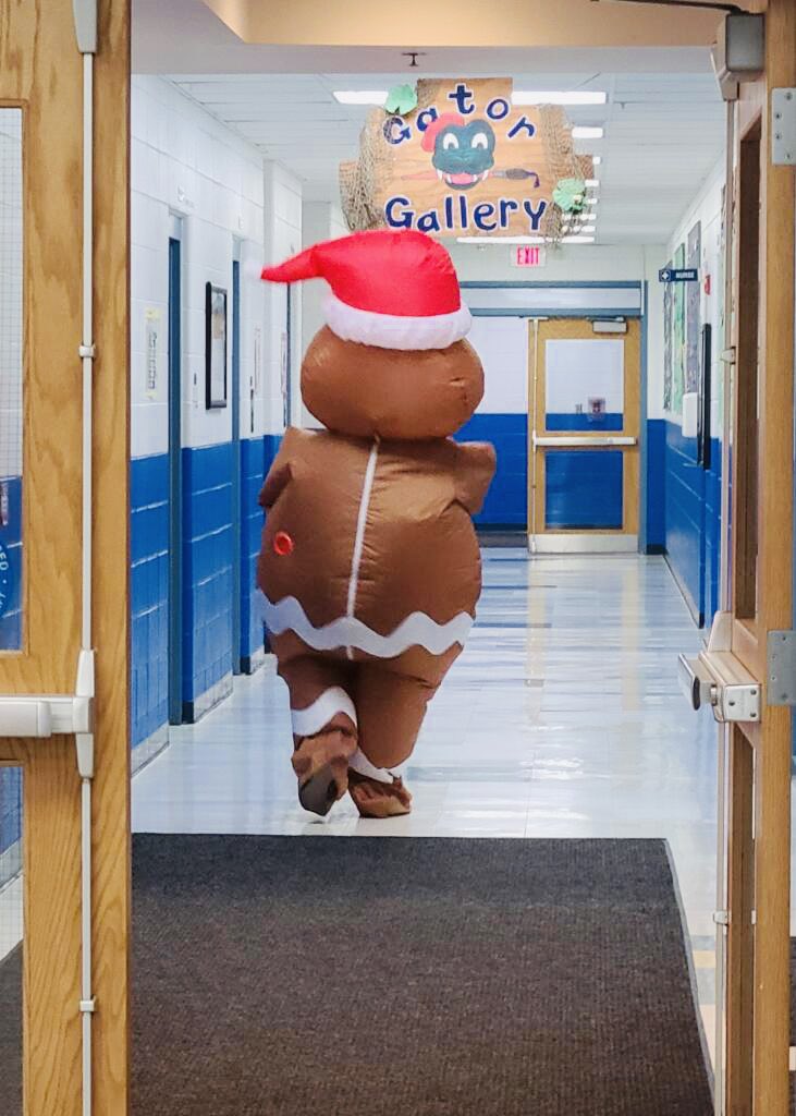 chrissyensign's tweet photo. Run run as fast as you can, you can’t catch me, I’m the gingerbread man! My favorite day of the year is back in person. That gingerbread man is loose in the school once again! If your kids ask…it wasn’t me! @GombertGators #notmygumdropbuttons #winterbreak #kindergarten https://t.co/eONNDitvjZ