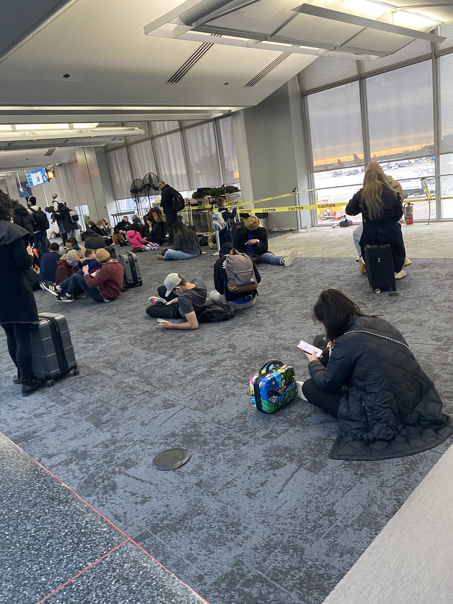 DomainsVvs's tweet photo. No seating at this gate, feelin like a hurricane feema camp in dis bitch, at least let us get some of those tin foil lookin blankets and sum MREs to complete the vibe https://t.co/rJfj8oHMGX