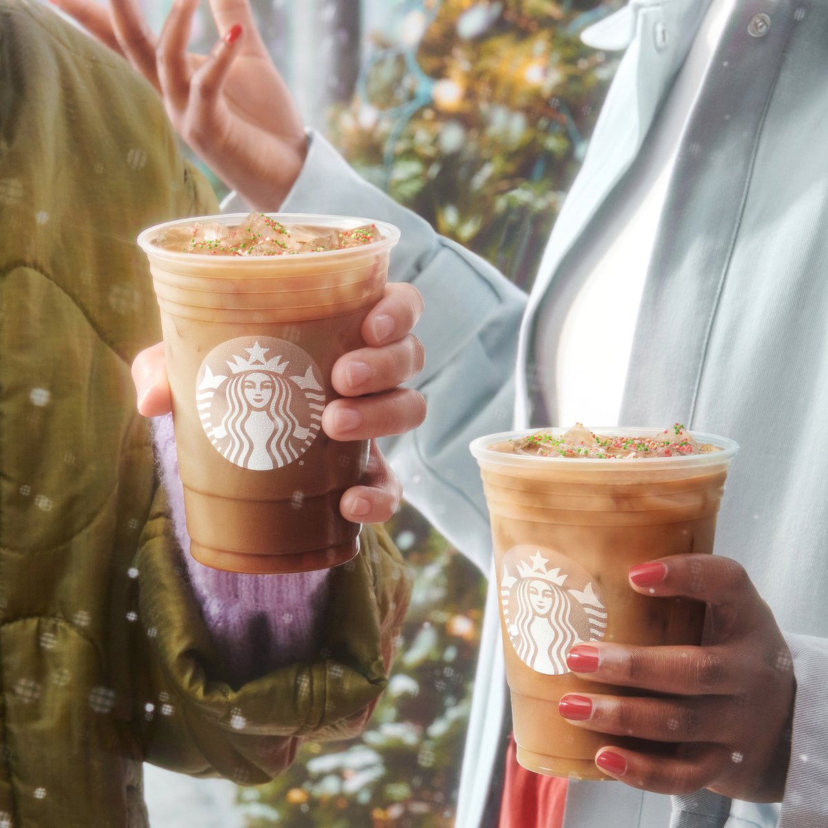 Two coworkers enjoy a coffee break with their Iced Sugar Cookie Almondmilk Lattes.