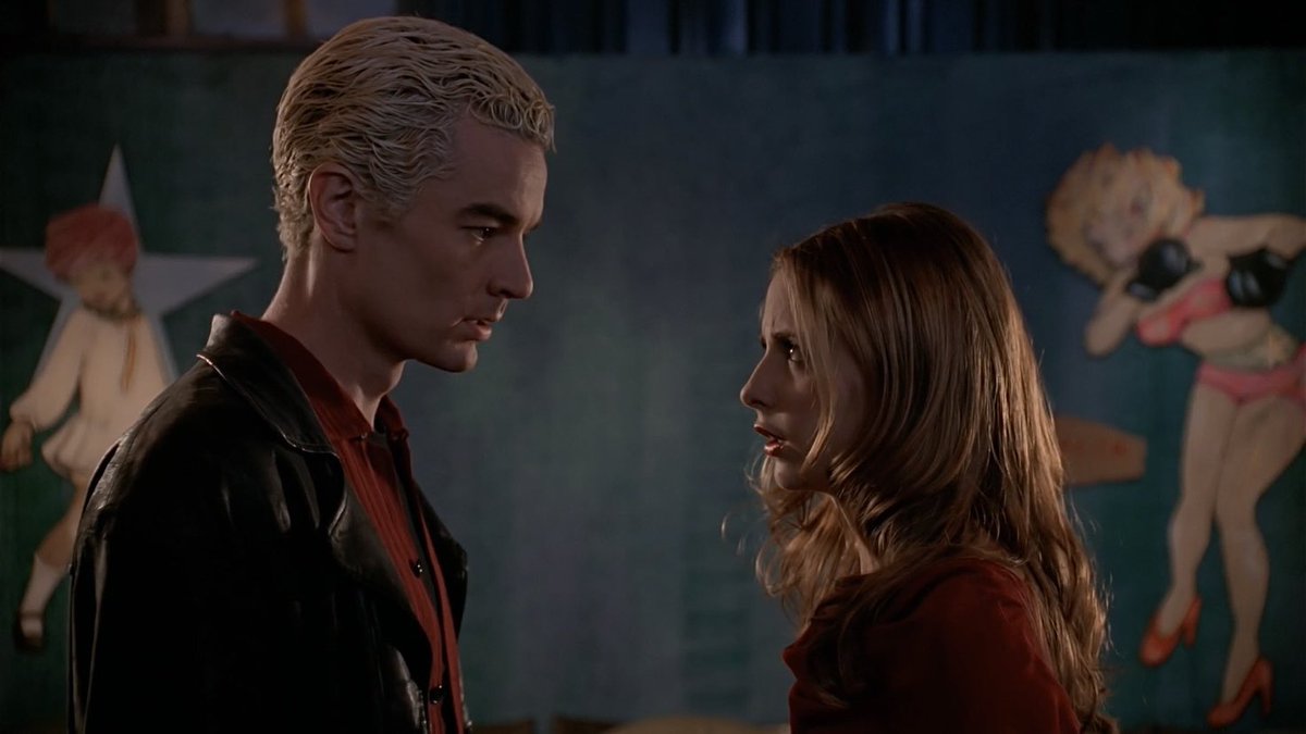 spike and buffy staring at each other in profile.