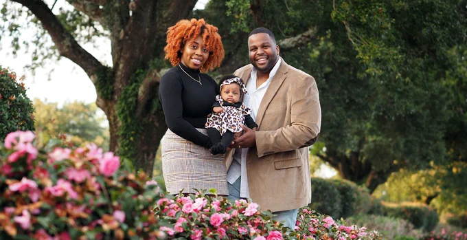 Diamond, Karis and Kenneth stand together beneath an oak tree on campus