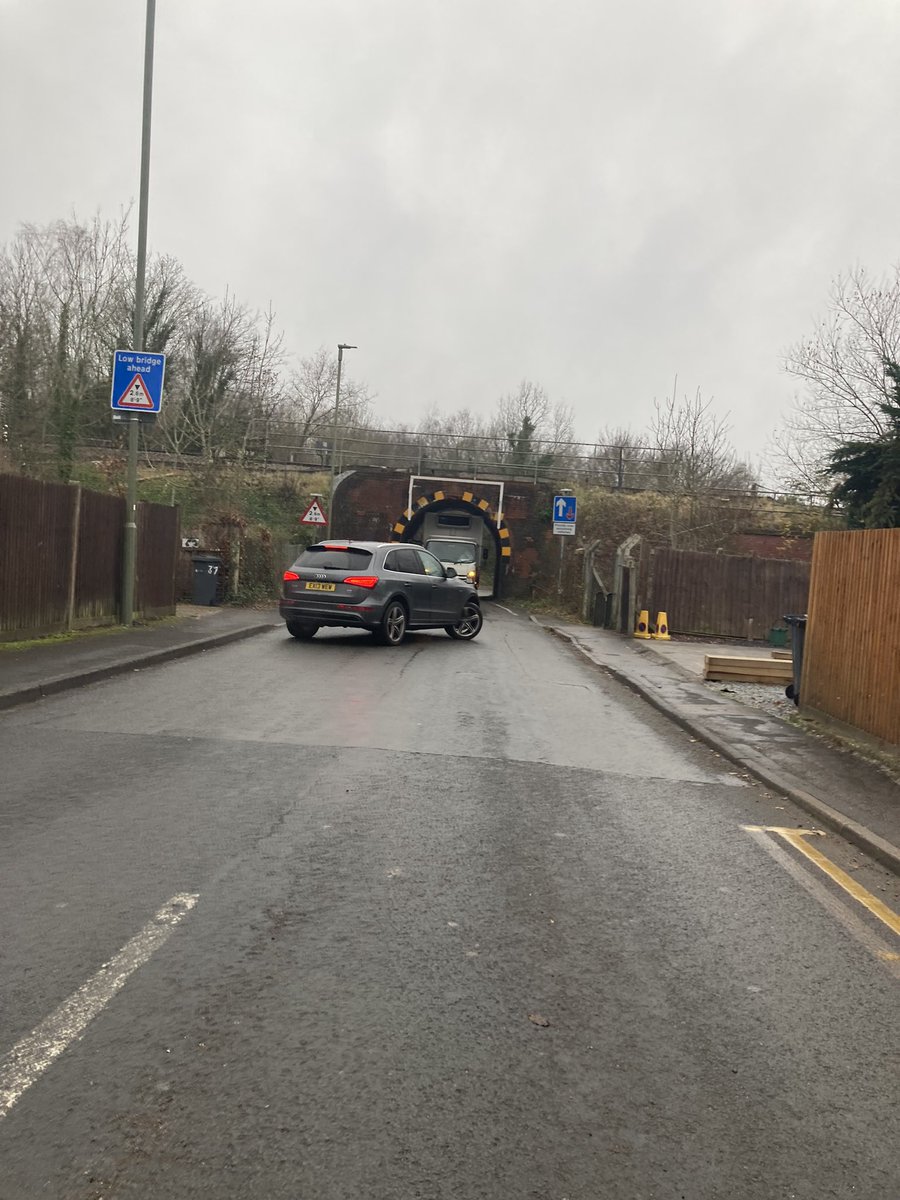 Pesky cyclists forcing a poor truck driver to go under a low bridge