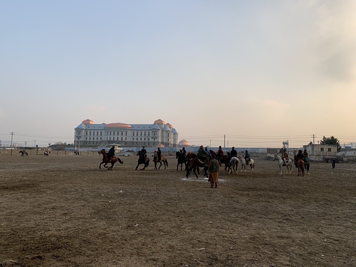 SecKermani's tweet photo. A buzkashi practise match in the shadow of the Dar ul Aman Palace in Kabul 

Interesting chatting to the mix of spectators including students, labourers, former Govt officials &amp; young Talibs 

w/ @AFZhwak 

📸 @gpjhill https://t.co/VyTKBBjsYm