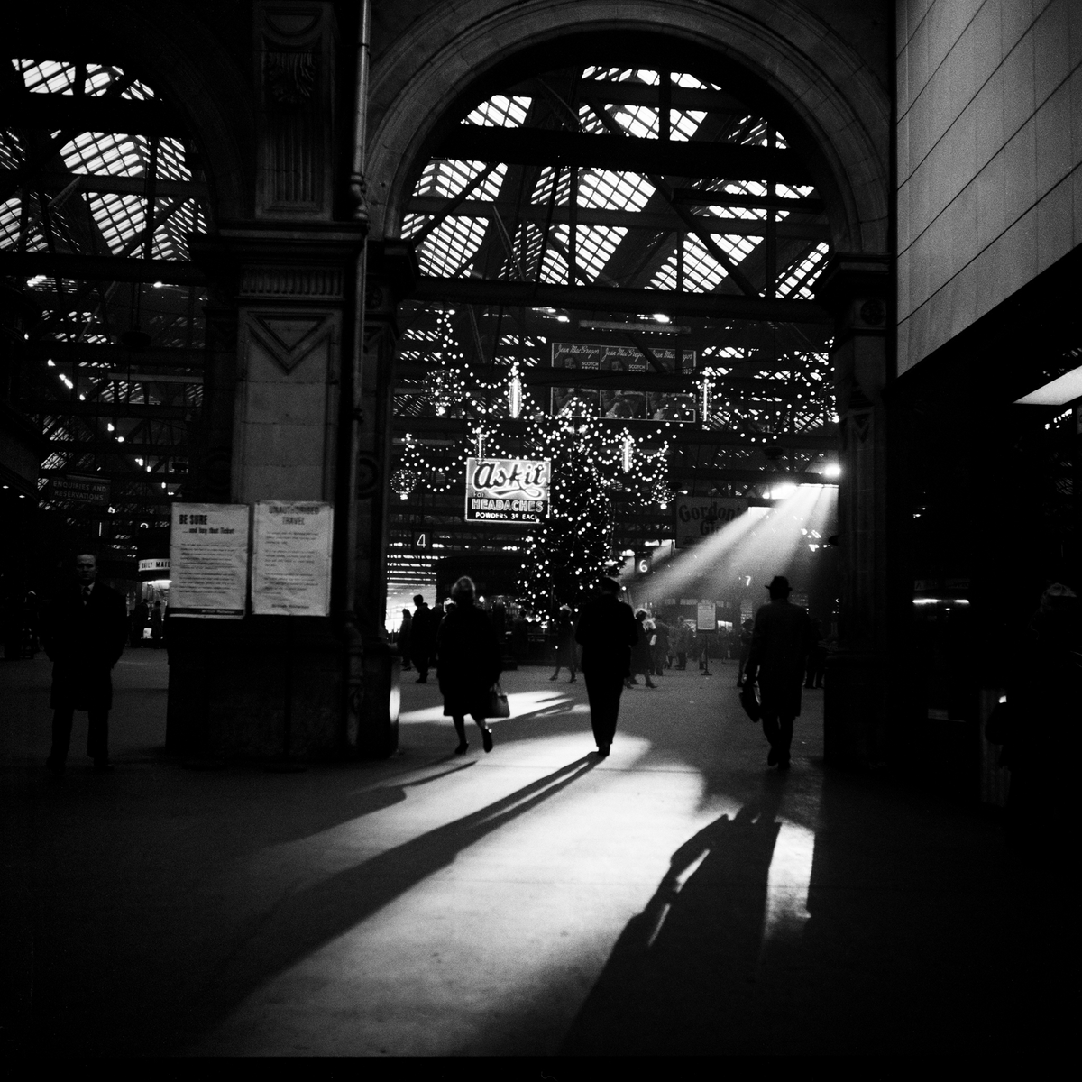 PastGlasgow's tweet photo. Long shadows and fairy lights at Glasgow Central, Christmas 1964. Captured by the inimitable Oscar Marzaroli who was waiting for, and found, the magic that day. https://t.co/BkRV71SgVx