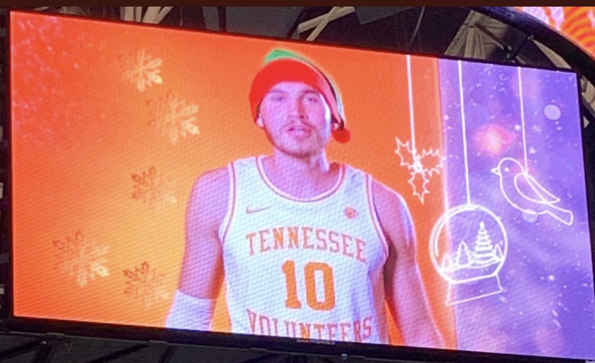 theSmokeyVol's tweet photo. Imagine being in the huddle in the middle of an intense game and your coach is yelling at you, and you look up at the Jumbotron and the white dude whooping your ass is singing Christmas carols with a Santa hat on. https://t.co/pZcRxnJX1N