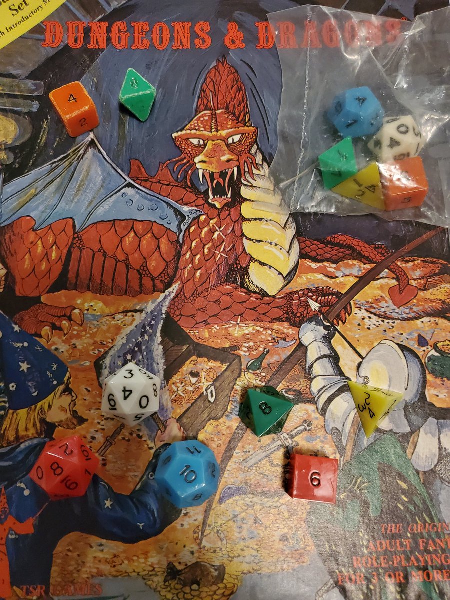 Pictured here on my Holmes Basic D&amp;D boxed set, from left to right, top to bottom, are my two surviving original dice from  40 years ago, a set of unopened dice that I picked up about 15 years ago, and a wonderful retro-set that I just received from Threshold Dice works. Cheers!