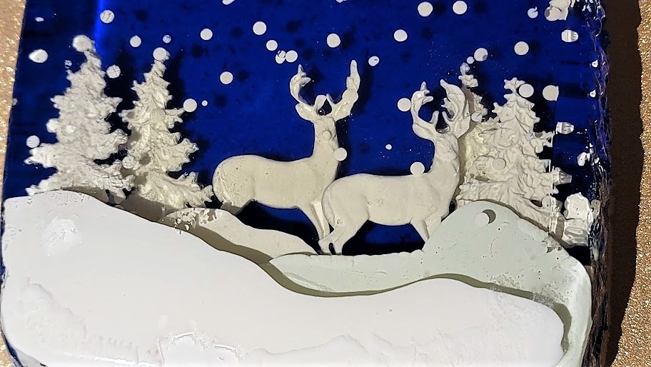 Christmas cake #1 - I made a vanilla and peppermint gelatin cake with deer, pine trees, and layers of snow, on top of a vanilla cream mousse.