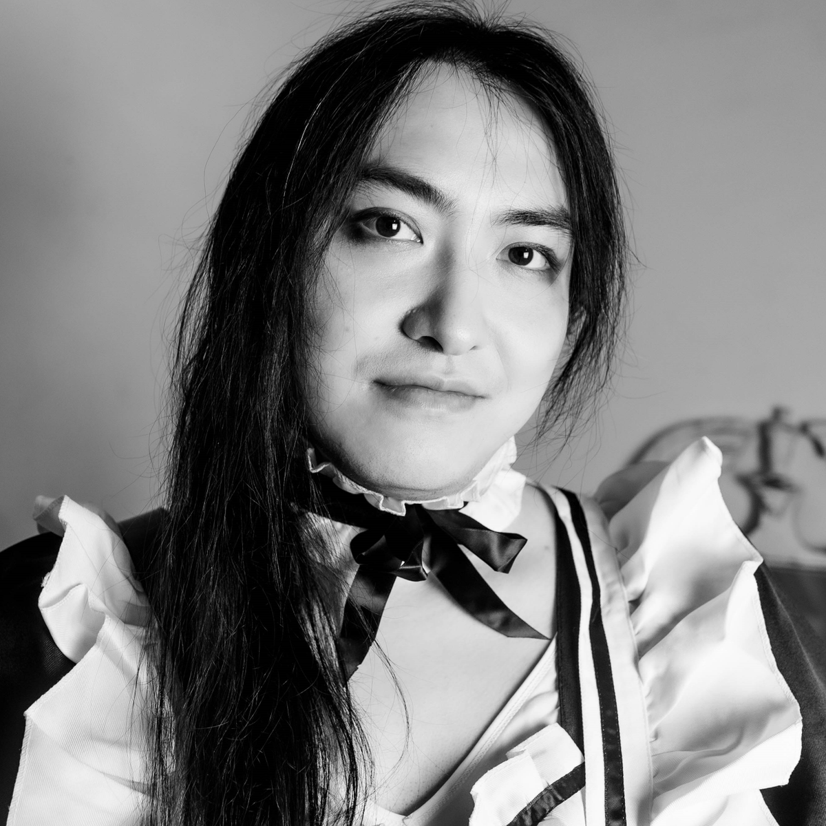 2 photos of me in the maid outfit. One is a closeup of my face, a single white hair is clearly visible as I look at the camera and give a faint smile.