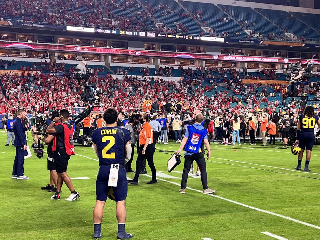 isaiahhole's tweet photo. Blake Corum staying out on the field (as are Mike Morris, J.J. McCarthy, Andrel Anthony, and Donovan Edwards) as the stage is set for Georgia to receive the Orange Bowl trophy. https://t.co/2sxSKnw6c6