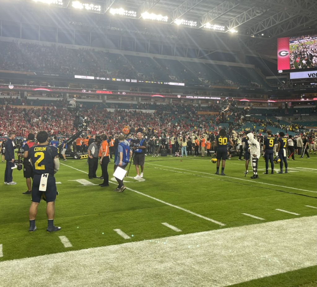 JoshPateCFB's tweet photo. Several Michigan players remained on the field to watch UGA’s trophy celebration 

JJ McCarthy, Donovan Edwards, Blake Corum, Andrel Anthony among them https://t.co/GfZTnrvJuR