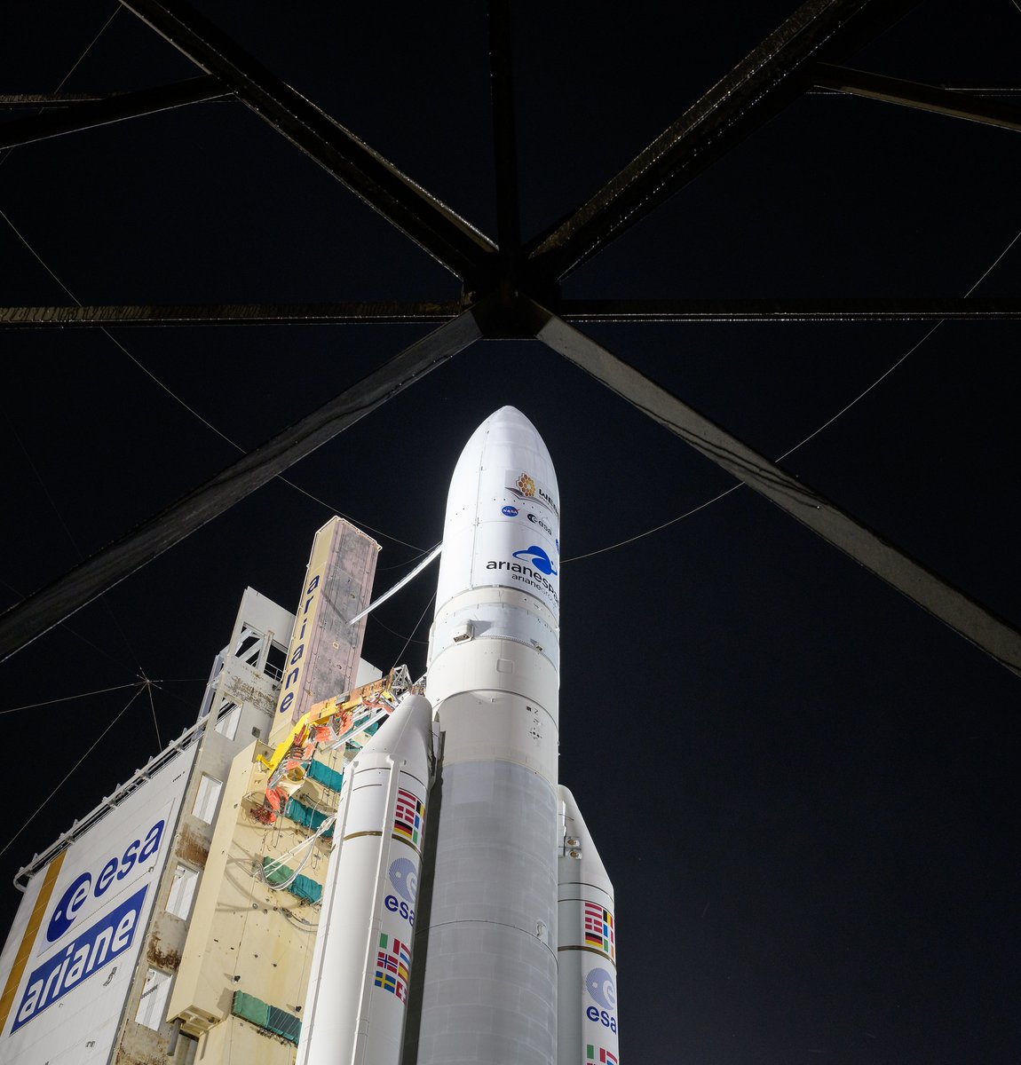 Arianespace's Ariane 5 rocket with NASA’s James Webb Space Telescope onboard, is seen at the launch pad, Thursday, Dec. 23, 2021, at Europe’s Spaceport, the Guiana Space Center in Kourou, French Guiana. The upper part of the rocket is visible against the night sky. Photo Credit: (NASA/Bill Ingalls)