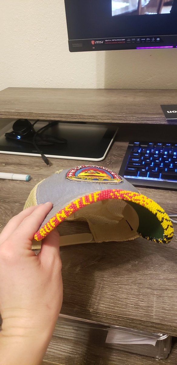 Uncle_Smidge's tweet photo. Effin' A, I just (passably) beaded my first hat brim. No pattern or anything, because wise resource planning is for chumps. Shaky AF but I picked an iffy base hat, so. BEDTIME NOW #LearningExperience #Beading #HRPufnstuf #NativeBeading #AmateurBeading #AuntiesBeading #BeadedHat https://t.co/ik4NQEnFAS