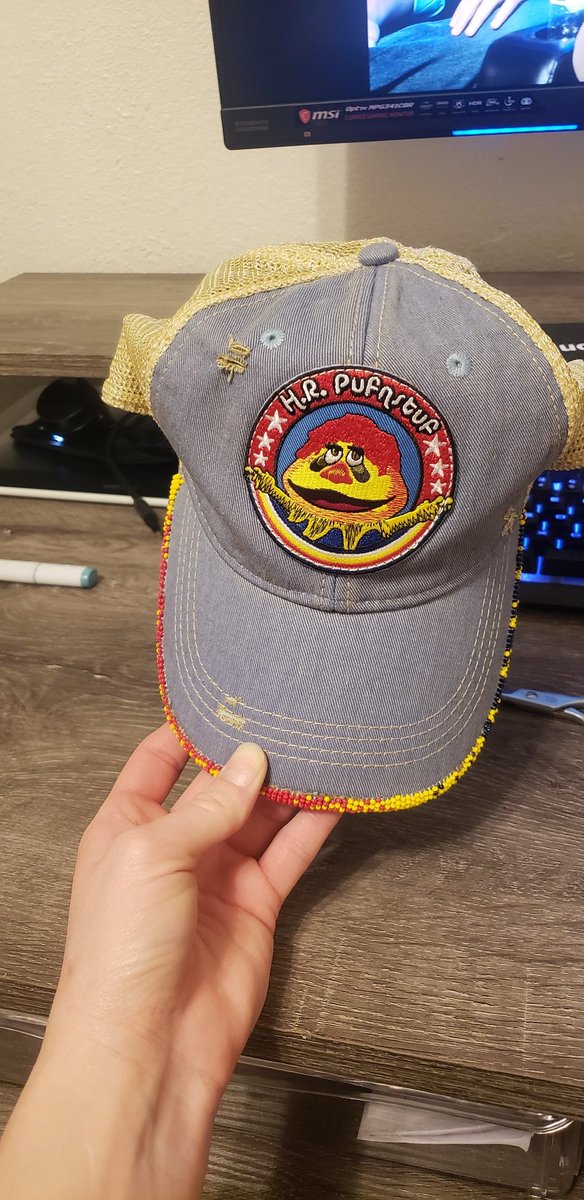 Uncle_Smidge's tweet photo. Effin' A, I just (passably) beaded my first hat brim. No pattern or anything, because wise resource planning is for chumps. Shaky AF but I picked an iffy base hat, so. BEDTIME NOW #LearningExperience #Beading #HRPufnstuf #NativeBeading #AmateurBeading #AuntiesBeading #BeadedHat https://t.co/ik4NQEnFAS