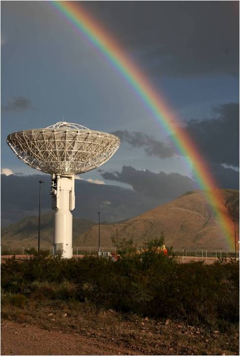 A photo of a Near Space Network antenna beneath a rainbow.