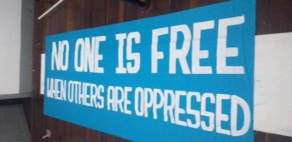 spring_2021's tweet photo. The protesters marched on the streets of Yangon to overthrow the Military Dictatorship by holding placards "No One Is Free When Others Are Oppressed". 

Even though SAC came and crackdown the protesters, all are safe.

#PropagandaOfWorld 
#Dec25Coup  
#WhatsHappeningInMyanmar https://t.co/yKidhH0Bn3
