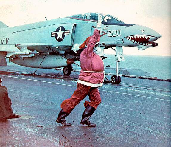 NavalInstitute's tweet image. Santa Claus launches an F-4B Phantom II from VF-111 Sundowners aboard USS Coral Sea (CVA-43) on Christmas Day in 1971. #Christmas