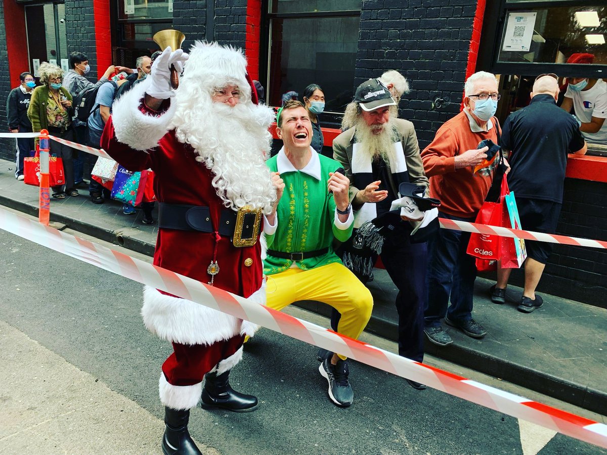 MSalvo614's tweet photo. On Christmas Day,  Collingwood Football Club's tall, tall forward, Mason Cox, squats next to Santa to get into his role as a green and gold Christmas elf at The Salvation Army Melbourne Project 614. A good time was had by all.  😀 https://t.co/5eAlEui10j