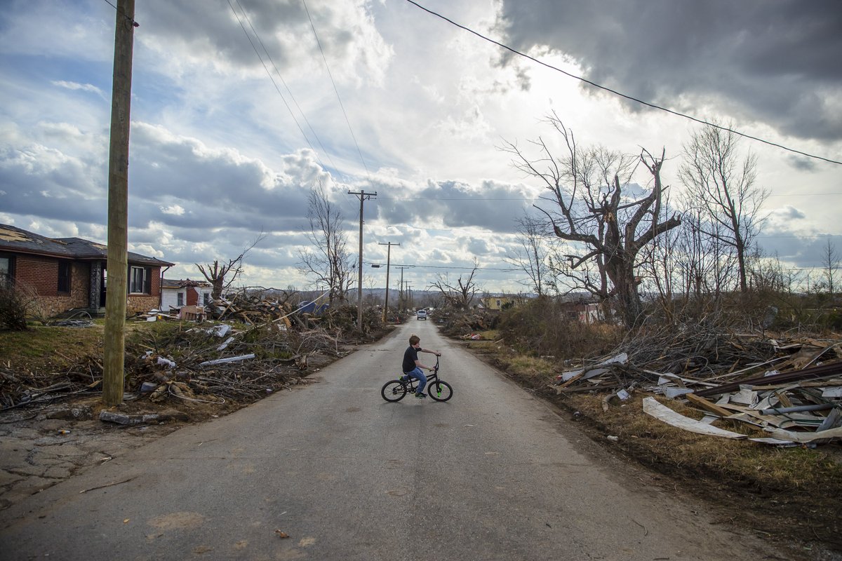 ryanhermens's tweet photo. On Christmas Day, Logan Peters, 11, takes his new bicycle on a test ride near his home in Dawson Springs, Kentucky. A deadly tornado destroyed his neighborhood – and much of his community – earlier this month. @heraldleader https://t.co/sh6YIpGCtT