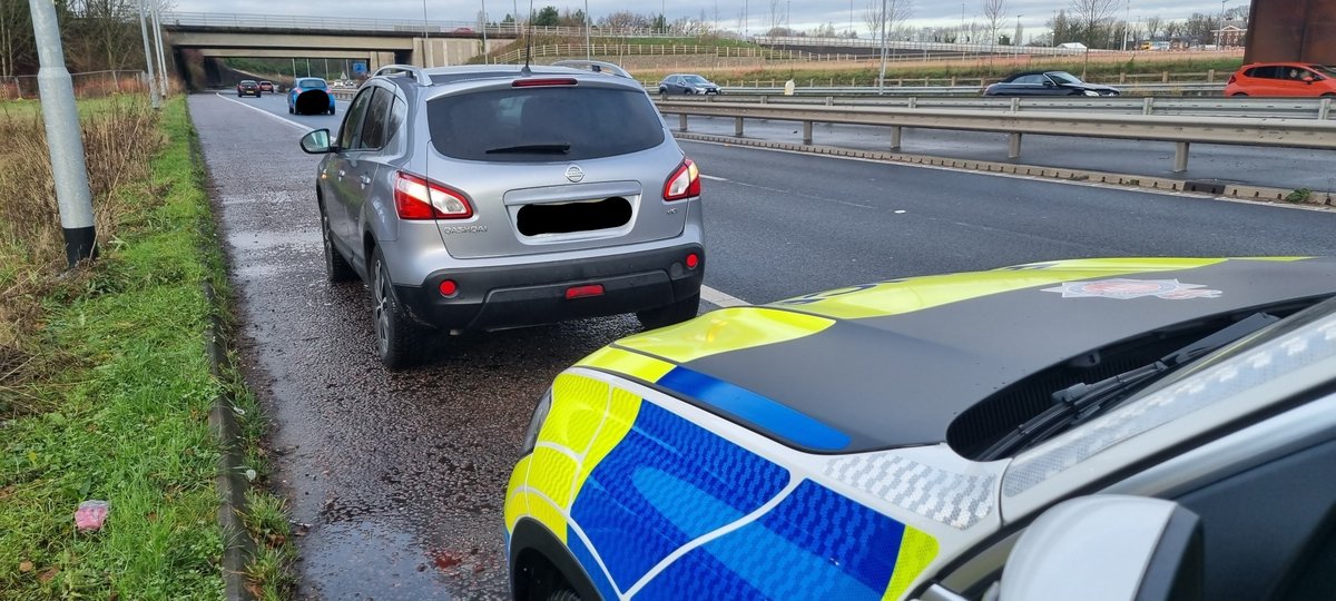 Driver stopped on the hard shoulder M56 Manchester Airport after collecting passengers from a flight - stopped to enter directions to Liverpool into a Sat Nav - TOR issued by our ME41.