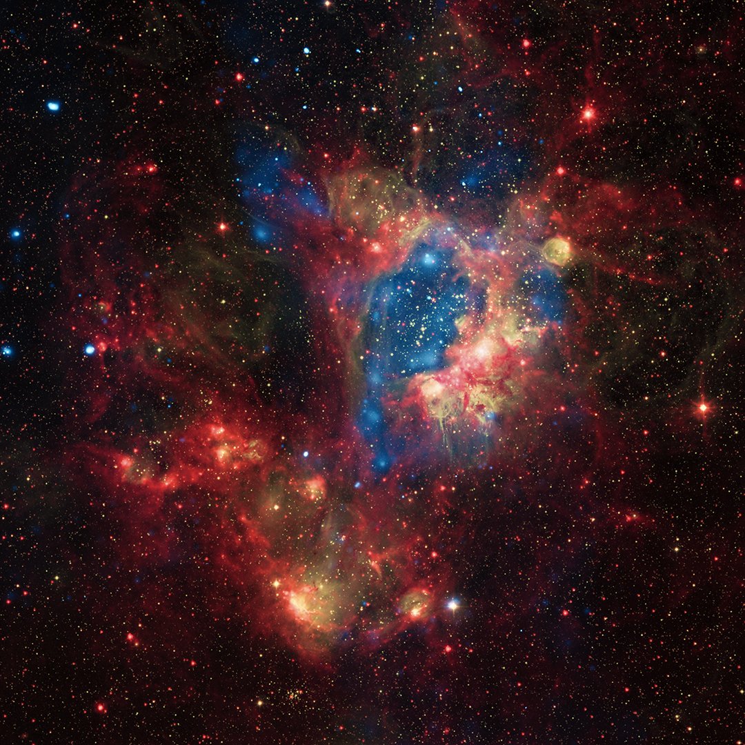 Stars in blue, red, and yellow are present throughout a wispy nebula that contains a few huge cavities. X-rays from NASA's Chandra X-ray Observatory (blue) show hot regions created by winds and shocks, while infrared data from NASA's Spitzer Space Telescope (red) outline where the dust and cooler gas are found. The optical light from the 2.2m Max-Planck-ESO telescope (yellow) in Chile shows where ultraviolet radiation from hot, young stars is causing gas in the nebula to glow.