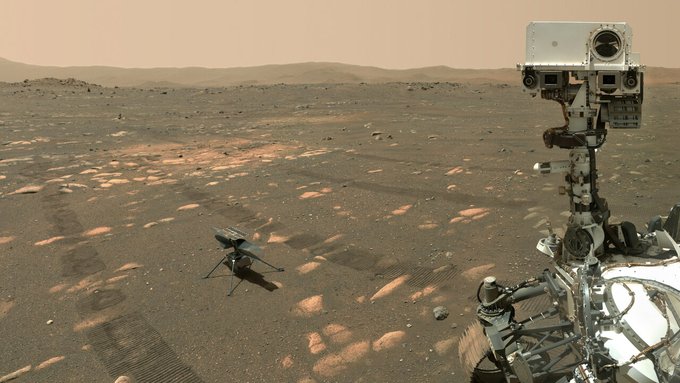 Perseverance rover selfie on Mars with Ingenuity helicopter nearby and rover tracks visible on the surface