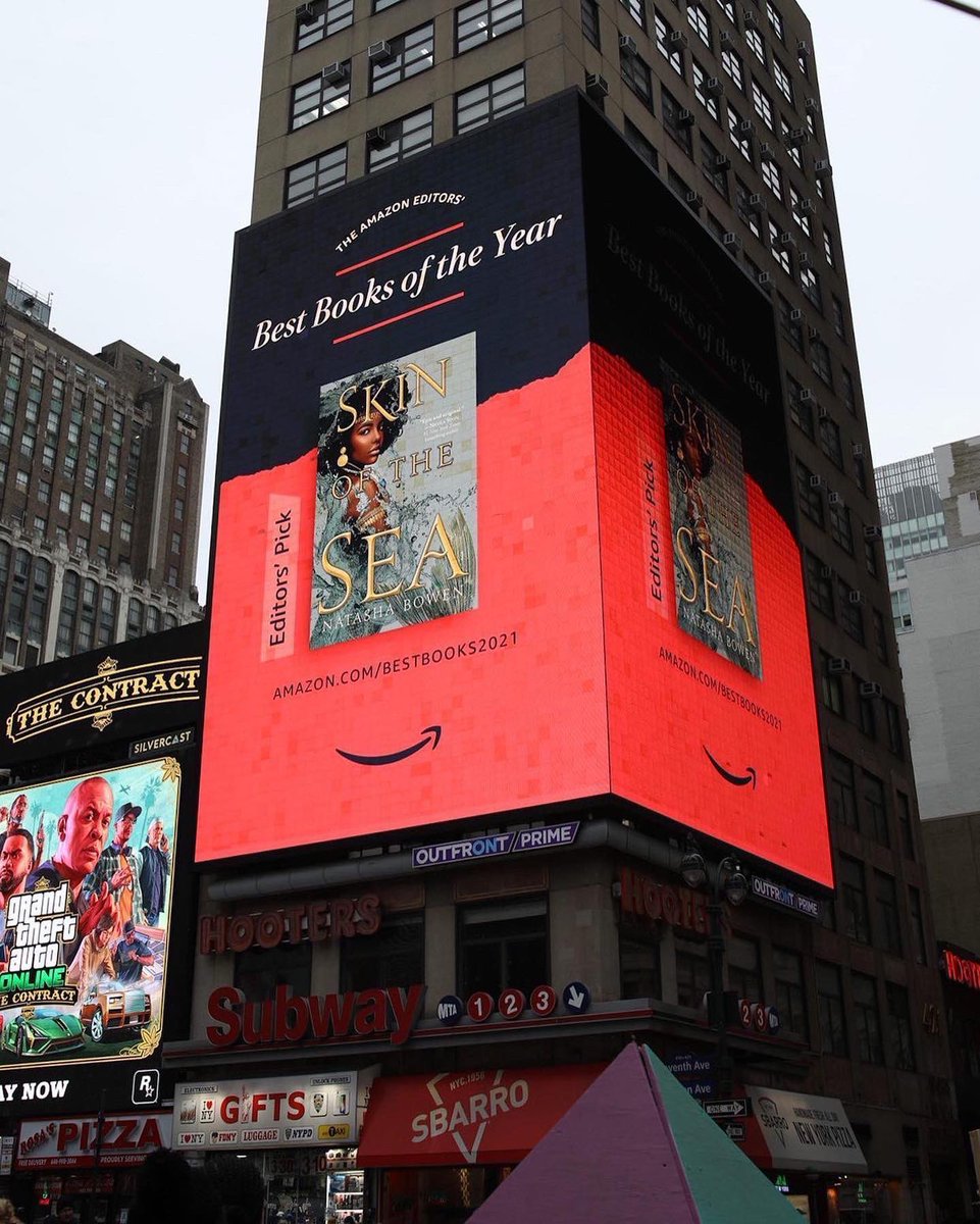 It’s here! What a way to end 2021! SKIN OF THE SEA is on the @amazonbooks billboard in Times Square! I am beyond proud to see this… to know all it represents. Get yourself a copy and find out — Can one mermaid change the waves of destiny? #skinofthesea #Blackmermaids