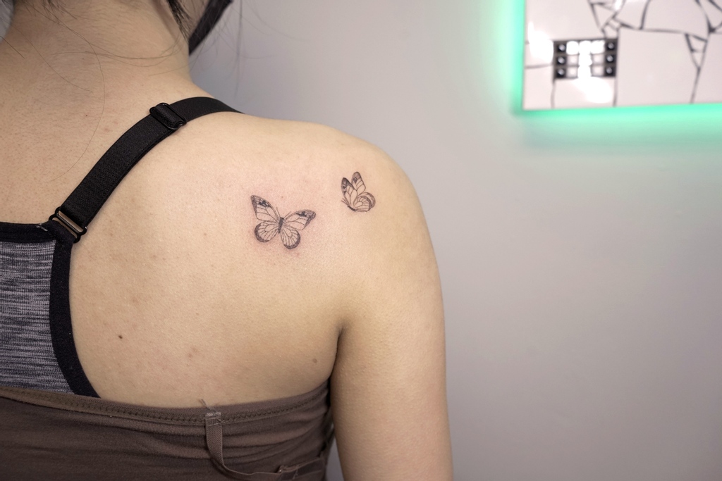 Colored Butterfly Tattoo On Left Back Shoulder
