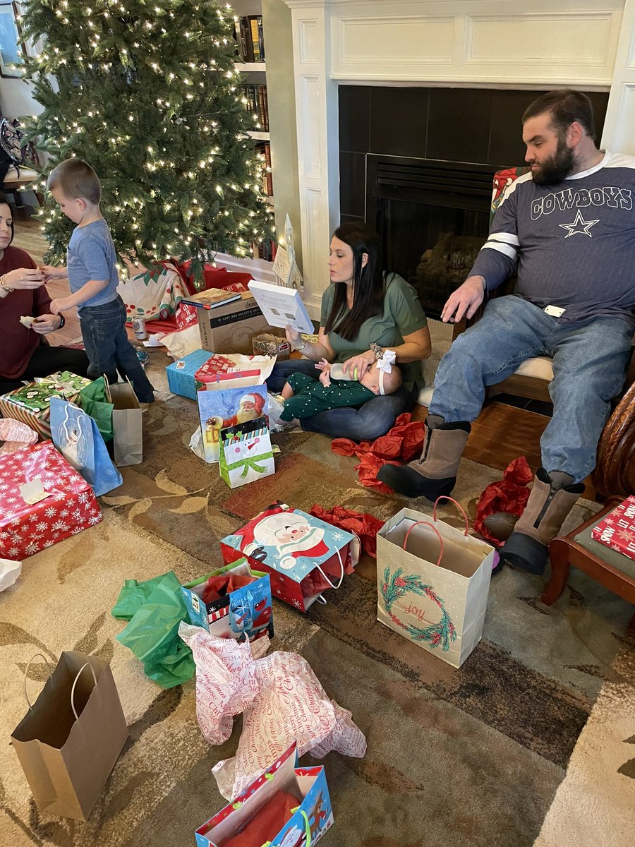 billfort2's tweet photo. My daughter-in-law is good at multitasking. She’s opening a present with one hand while feeding my granddaughter with the other. https://t.co/eOrzSeAcH3
