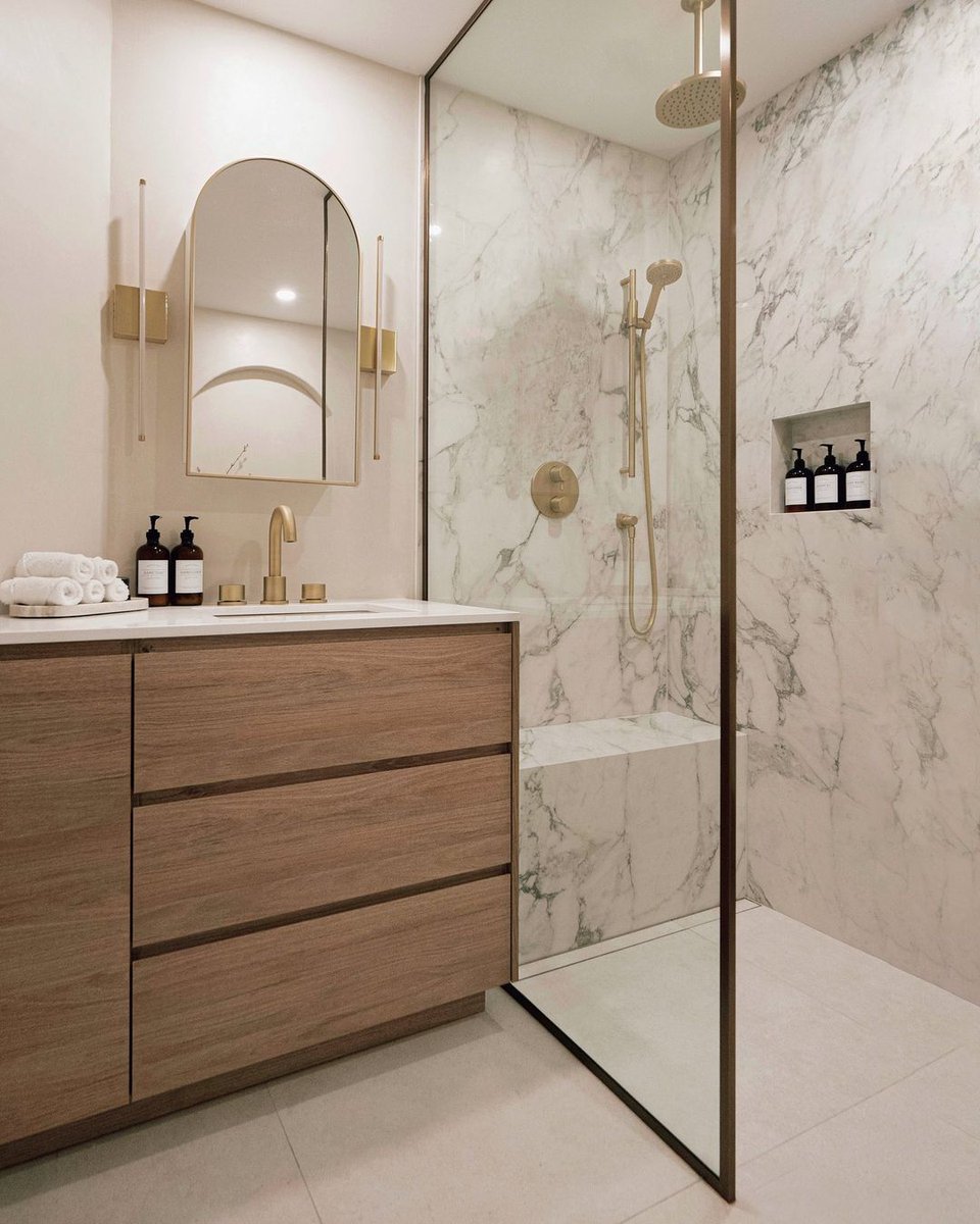 Warm neutral tones are set off by gold hardware in this luxe bathroom by @fernandfigdesign with Schluter-Systems North America . 

This gorgeous project features floors warmed by Ditra-Heat, Kerdi bench and niche, and tileable Kerdi-Line linear drain. @ericbranover

<a href="/schluterNA/">Schluter-Systems NA</a>