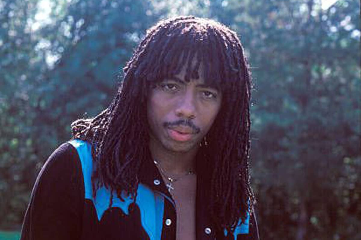 Rick James standing outdoors in the 1980s.