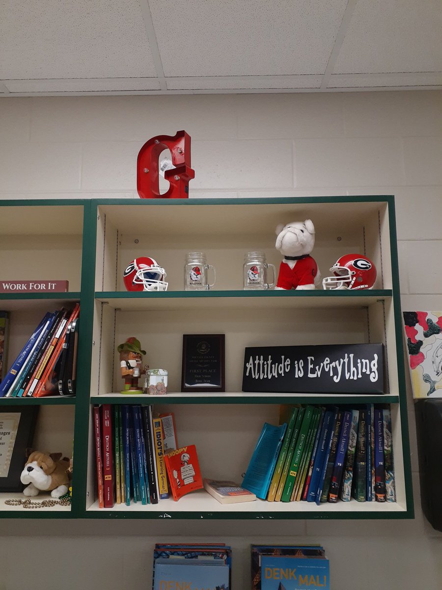 KimSibio's tweet photo. While the shelves in my classroom are usually filled with German books, one shelf is reserved for my Alma Mater - - congrats Dawgs on a sweet victory last night!! #WeAreDeLand https://t.co/SbacmSqBnt